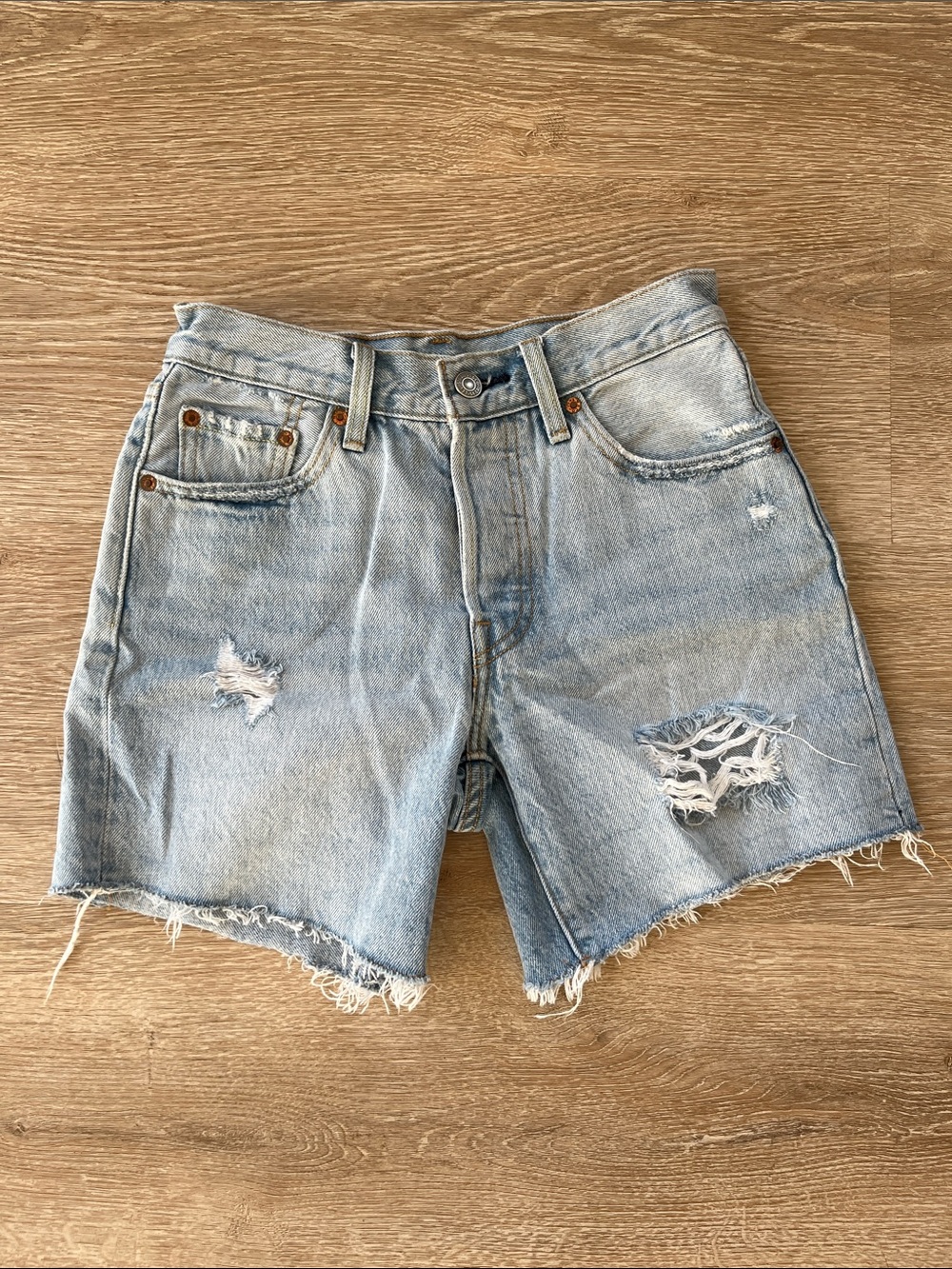 Levi’s 501 cut off denim shorts button fly distressed light blue wash size 24